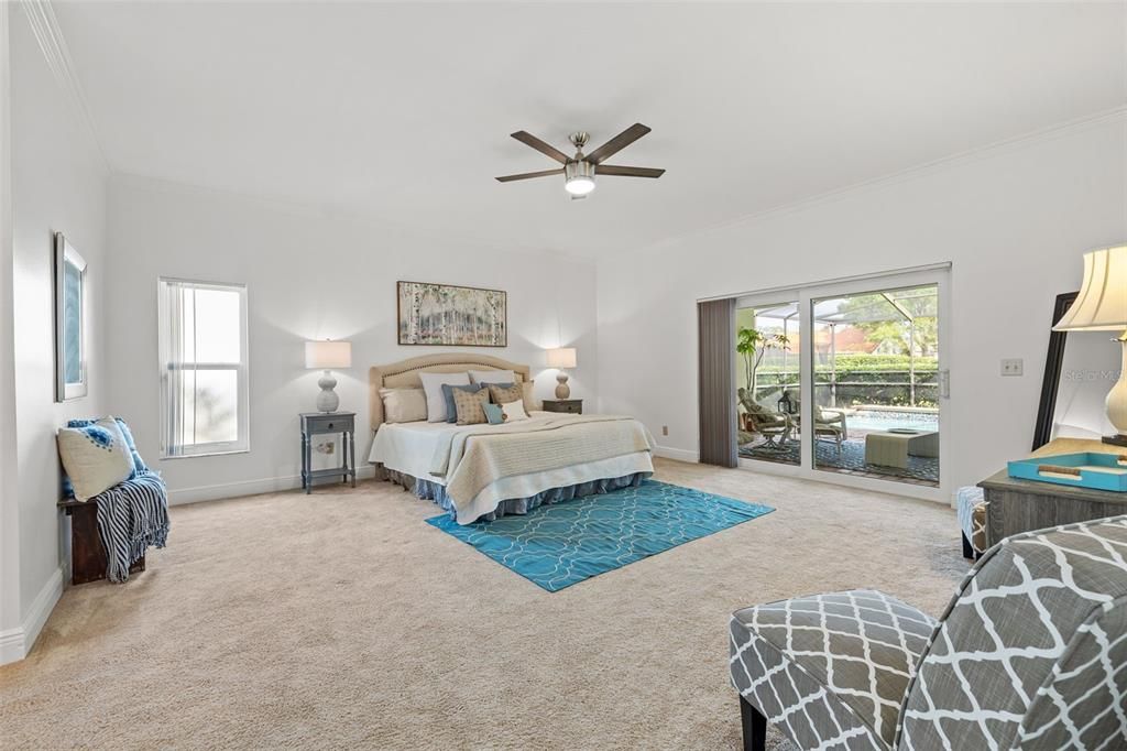 Oversized master bedroom with sliders leading to patio and backyard