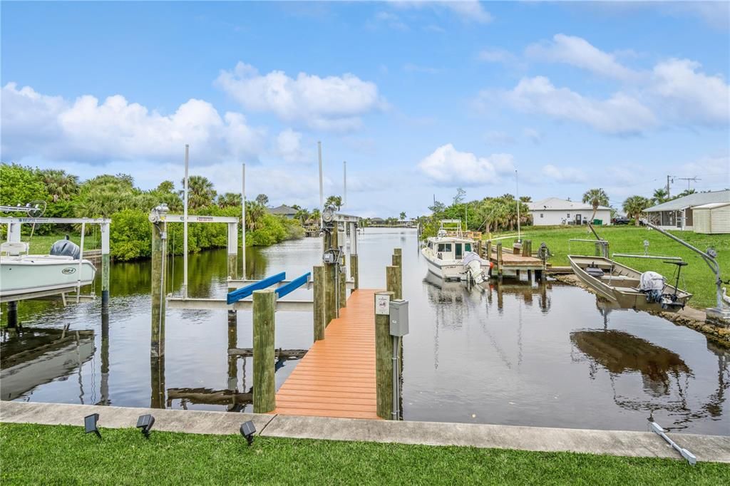 view of canal with new dock and boat lift