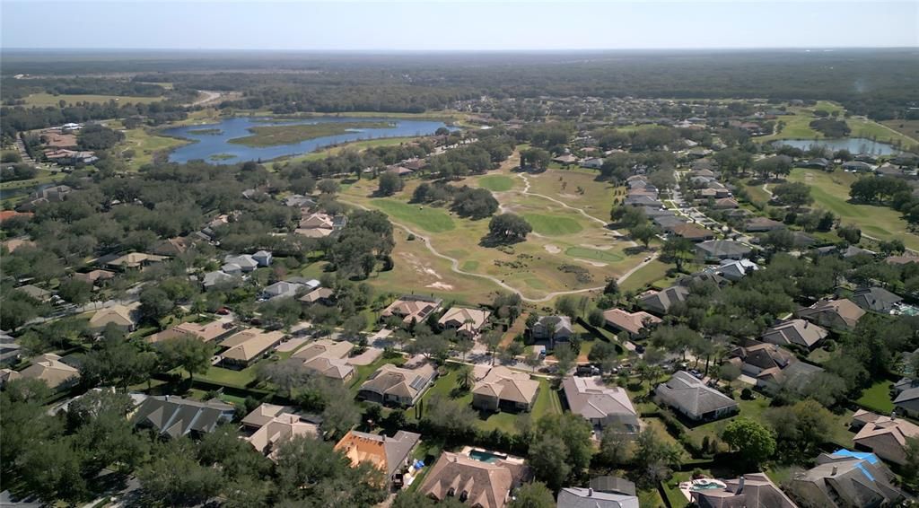Aerial shot overlooking 32634 View Haven Ln and the view of the 13th hole and the fairways