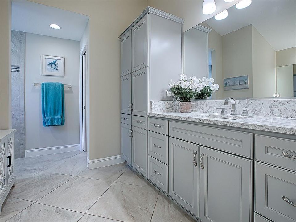 HUGE master bath with split vanities and TWO HUGE walk in closets, as well as a tiled Roman styled shower with corner bench