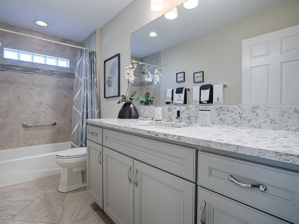 Bath #2 / Guest Wing Bath is supersized with tub/shower combo and loads of storage, as well as QUARTZ countertops