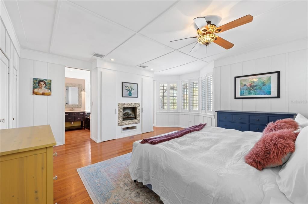 Spacious Master Bedroom with gorgeous detailed woodwork and two-sided fireplace.