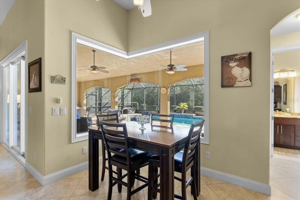 Eat in kitchen with mitered window looking to pool and lanai