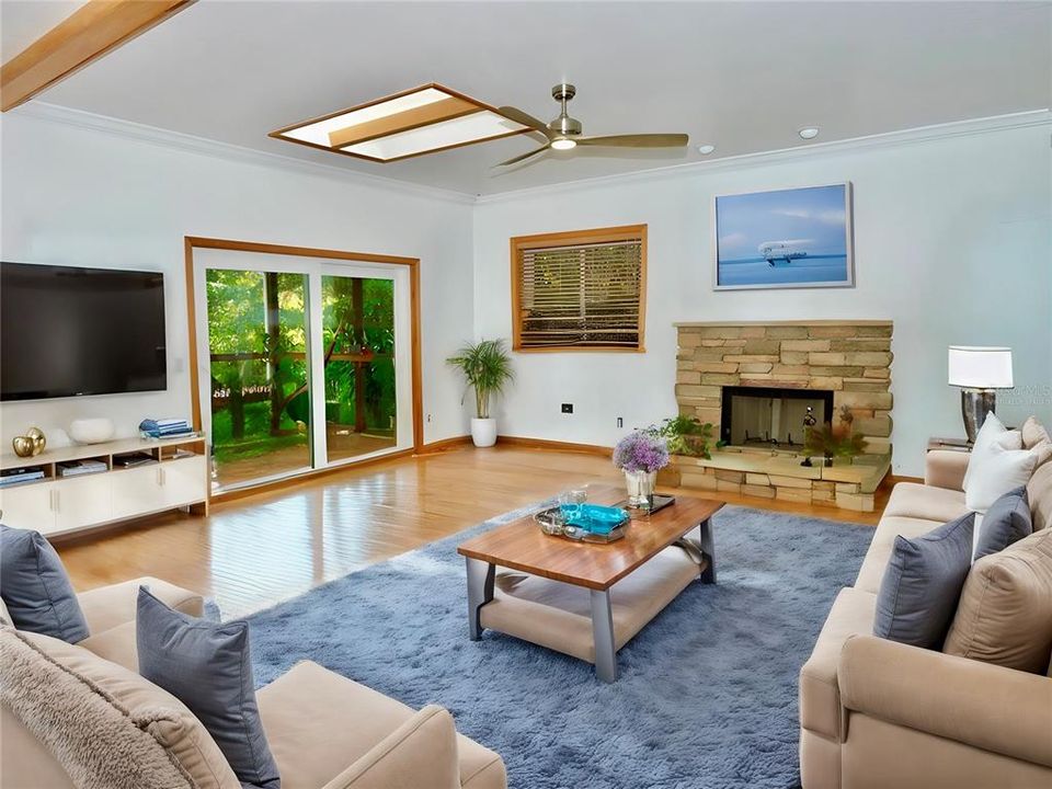 Virtually staged... Living room with vaulted ceilings, skylight & room to entertain.