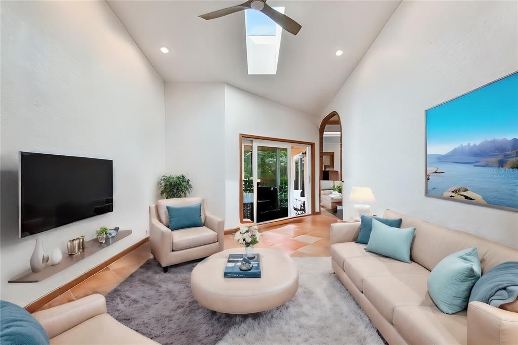 Virtually staged... Another skylight in this family room off of kitchen and lanai access