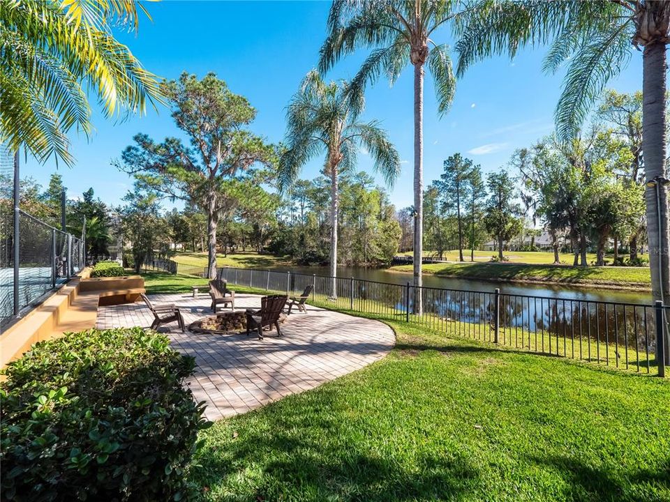 Fire pit with plenty of seating overlooking the water and golf course