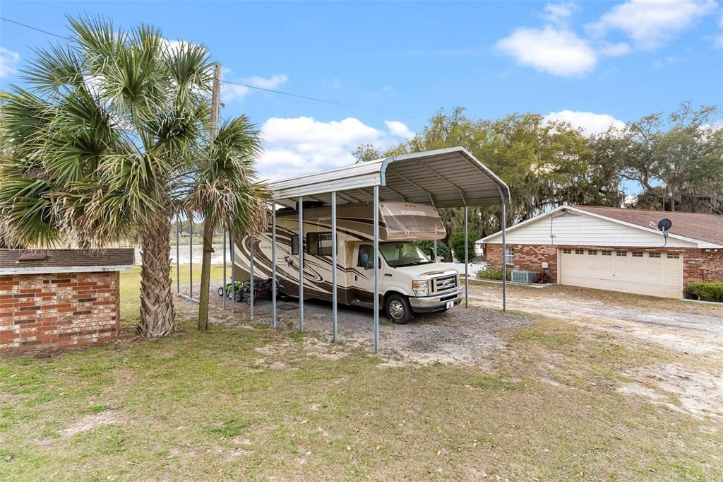 Home features Large RV Carport Storage with Electric Hook Up and Water Available