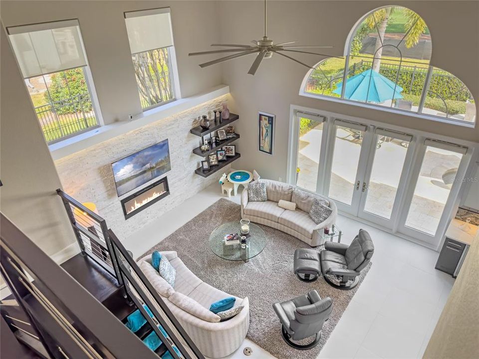 Stunning view of Family Room with Volume Ceilings, Sliding Doors and Stairway