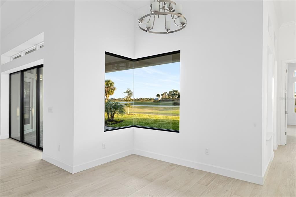 Eat in kitchen with seamless window overlooking the green of hole number one.
