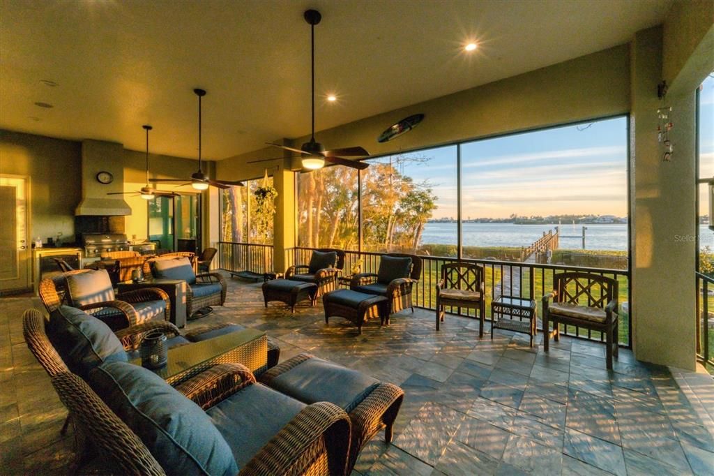 Screened lanai with an outdoor grill and a slider from a guest room to lanai