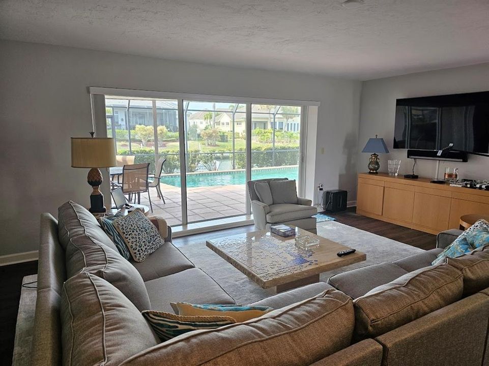 Living Room with large sliders to Lanai and Pool