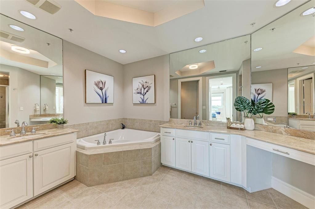Owners en suite with solid wood Masterpiece dovetail cabinetry, marble countertops, soaking tub, separate shower and water closet.