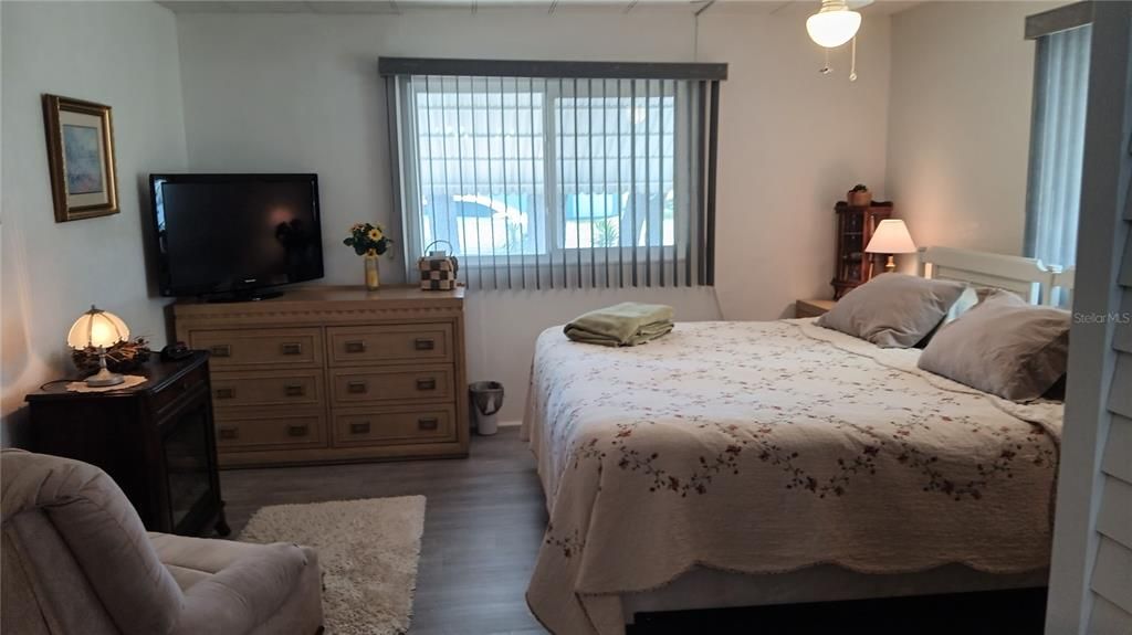 Bedroom is spacious and comfortable.  Chair and Electric Fireplace are not included, but the dresser, bed, tv, lamps and nightstands stay for the new owner!