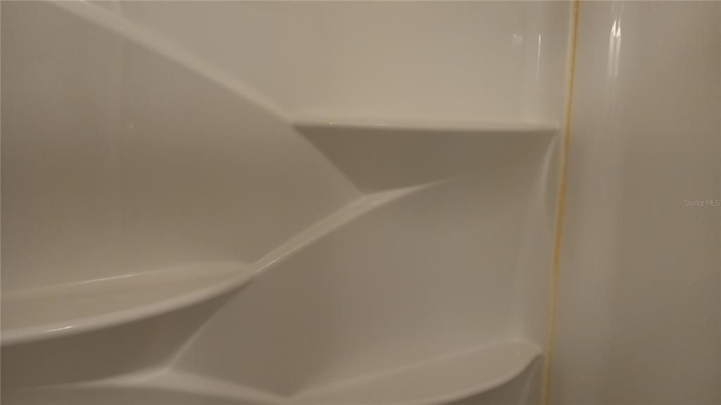 The tub enclosure in the 2nd bath has multiple shelves built in
