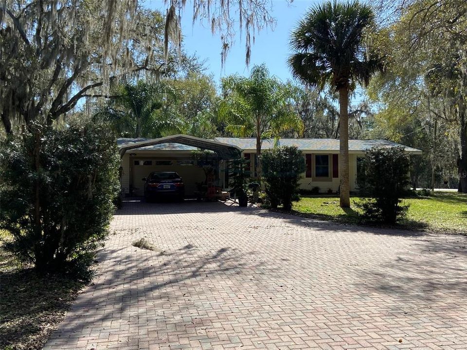 Home and Carport in front of 2 car garage.