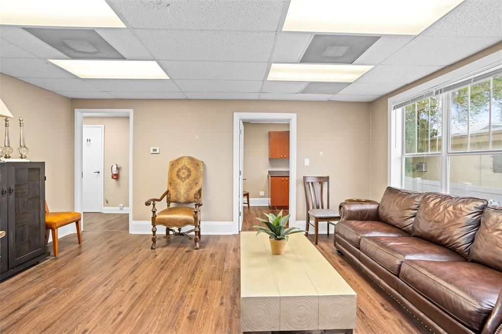 Secondary reception area with private room that can be used as an office or treatment room.