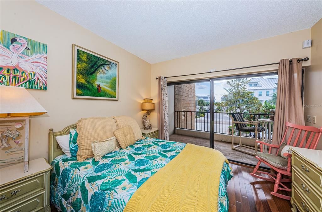.. 12 x 11 Guest Bedroom with Brazilian Teak Hardwood Floors -  Has Access to the 23  X 5' 7" Rear Balcony.. The Condo Has an East / West Run To it..