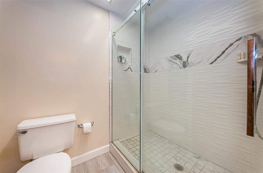 ... 2nd  Bathroom Services Both Guest Bedrooms.. Bathroom Has a Split  Floorplan with a Vanity Area and a Walk In Shower Area. Photo Shows The Shower or Wet Areas..