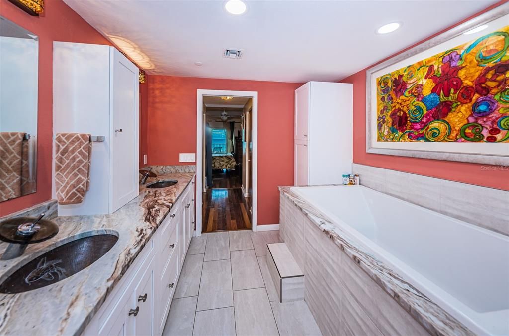 .. Large Soaking Tub .. Hallway to Master Bedroom with Wood Floor contain His & Her Closets.