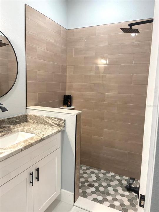 primary bath with tiled walk in shower