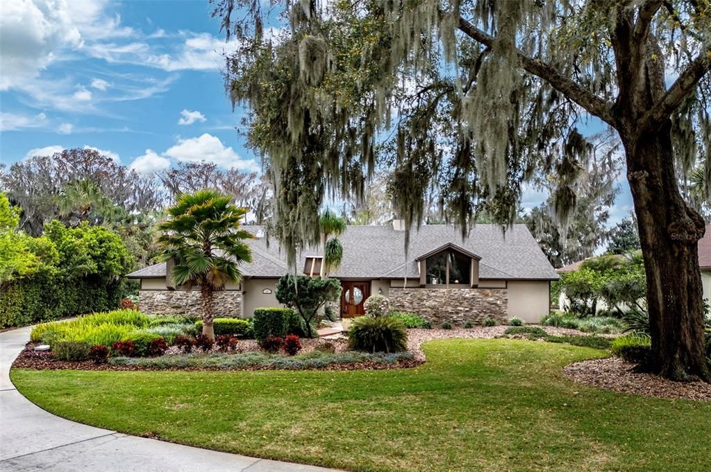 Beautifully landscaped and shaded by great oaks