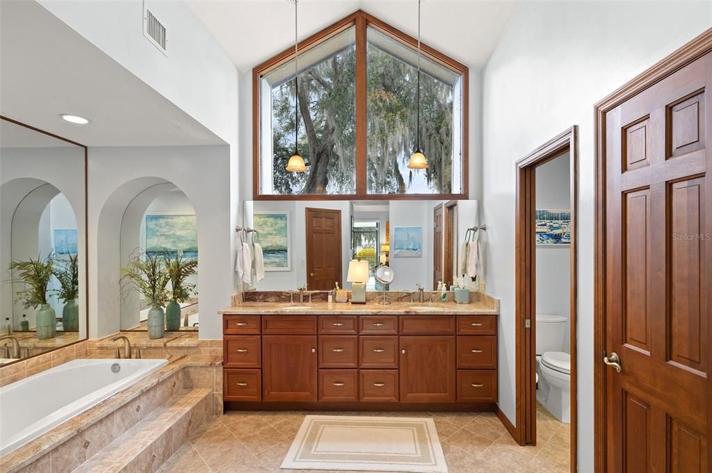 En-suite bath has vaulted ceilings and stunning large windows