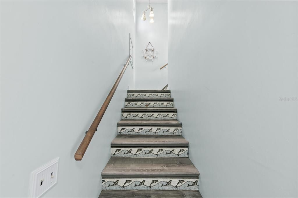 Stairs leading to primary bedroom