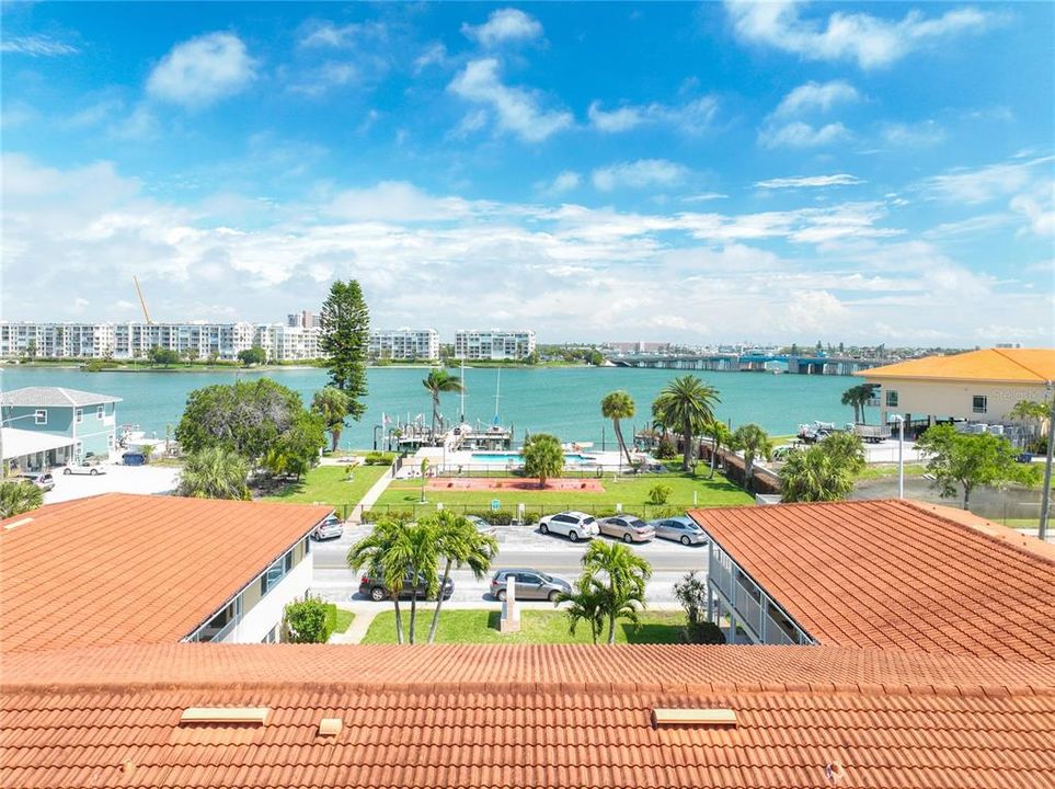 7740 Boca Ciega Dr- Waterfront condo community. The pool across the street, as well as the dock, belong to this community. The building to the right is the St Pete Beach Community & Aquatic Center.
