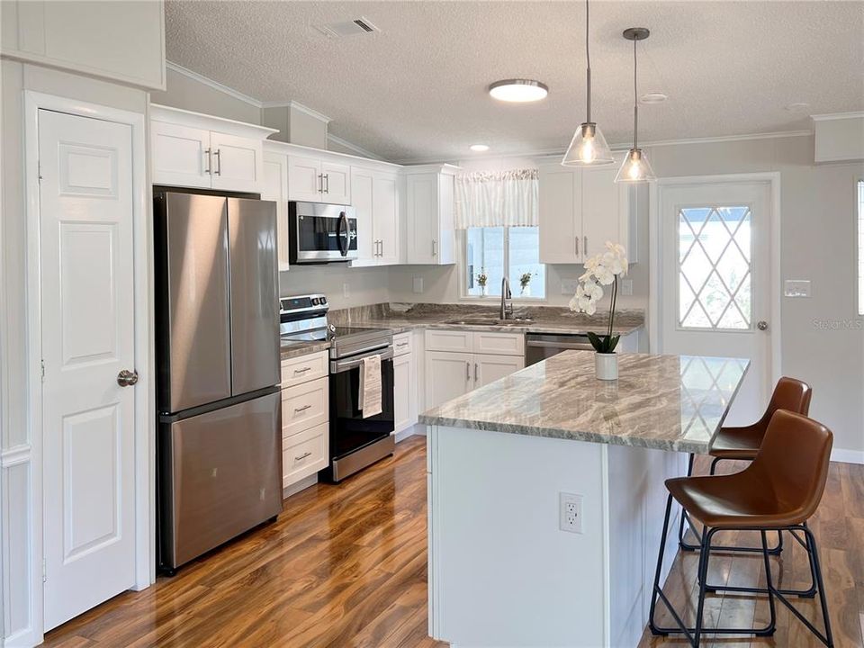 Newly renovated Kitchen featuring White Shaker Cabinets, Granite Countertops and Stainless Steel Appliances.