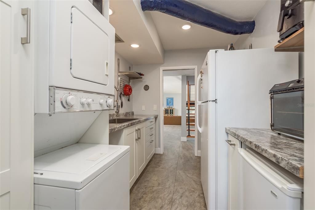 Butler's pantry w/oversized sink/prep area, first floor washer/dryer and storage area. 2nd Refrigerator and freezer convey