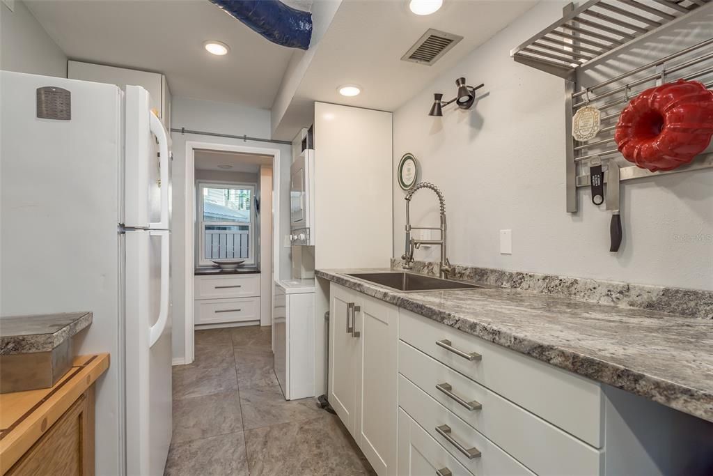 Butler's pantry w/oversized sink/prep area, first floor washer/dryer and storage area. 2nd Refrigerator and freezer convey