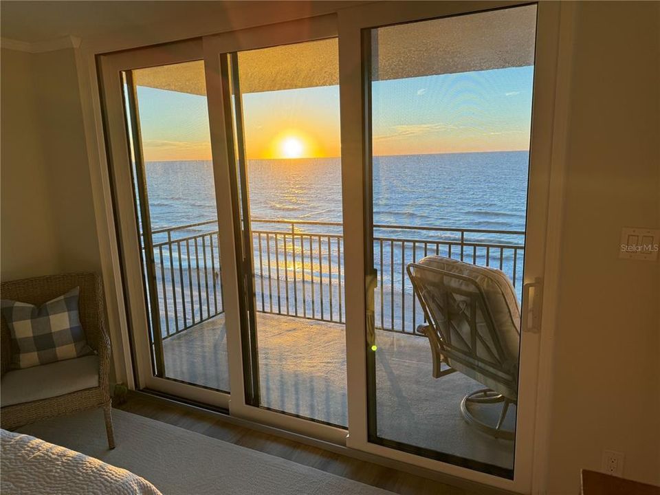 Primary Bedroom Sunset- all 3 bedrooms have balcony views and floor to ceiling sliding doors.