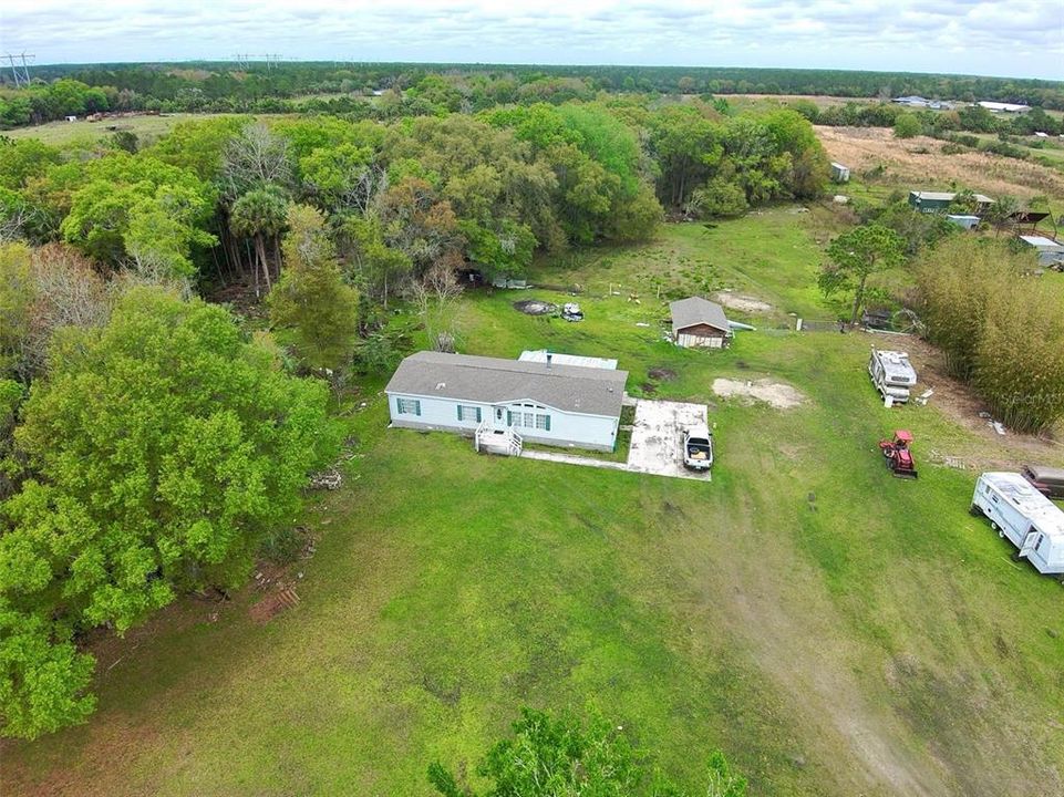 330 Sq foot block construction mini workshop pictured behind main home