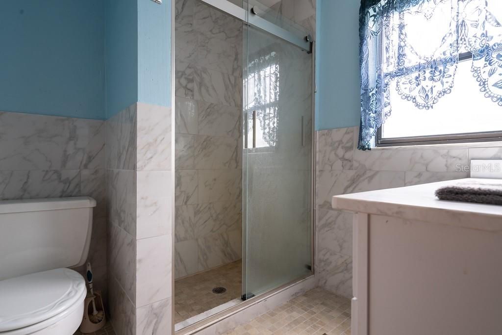 Ensuite bathroom with walk-in tiled glass shower