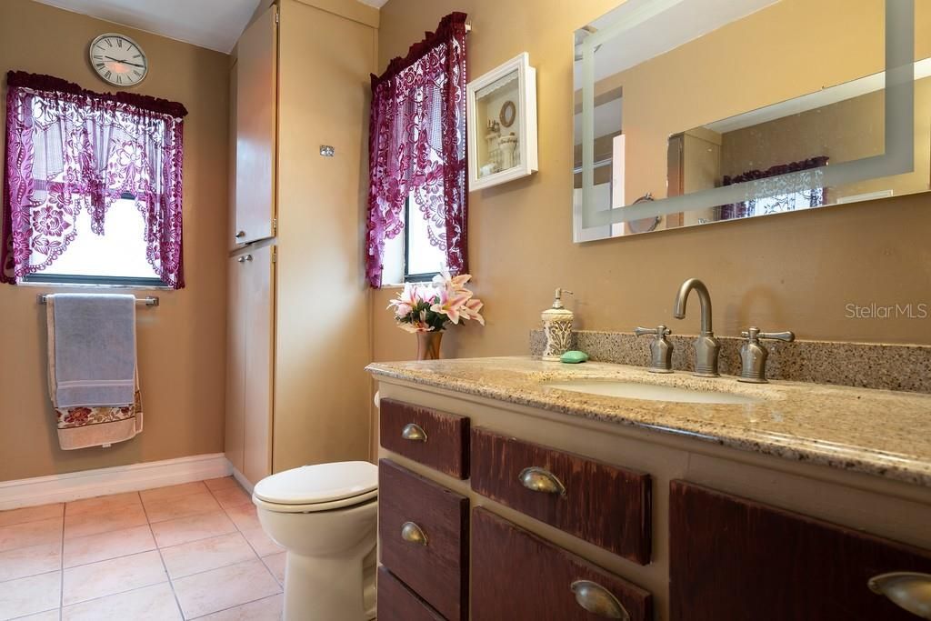 Bathroom #2 features granite counter tops, walk-in shower and an extra linen closet