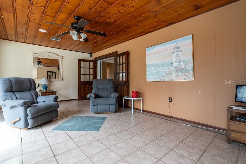 Florida sun room also features all real wood ceiling and a perfect view of the pool area