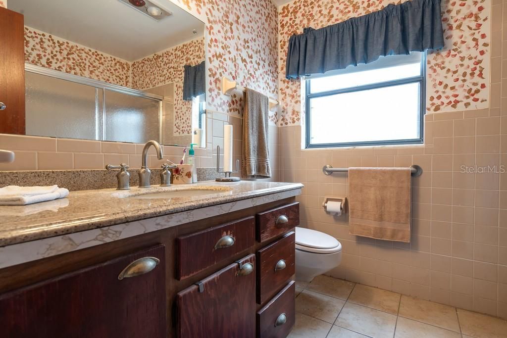 Bathroom #3 features include a walk-in shower and single vanity with plenty storage space.