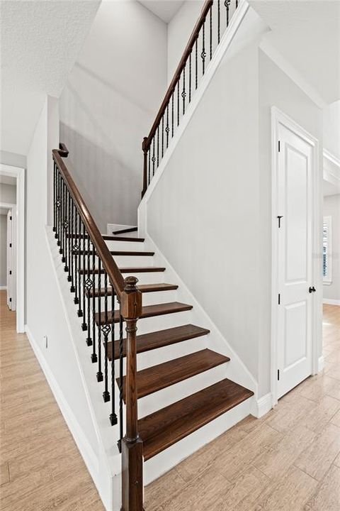 Beautiful wood stair case extends to the second level