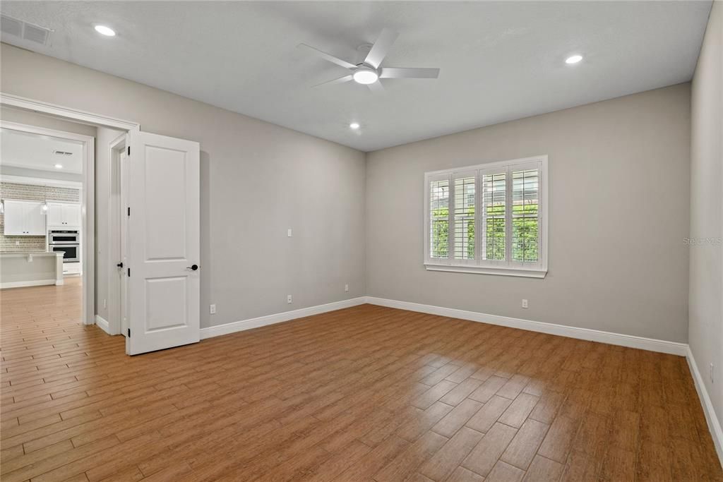 Enormous main level office/den with French doors is the perfect space for a home office, gym or play room