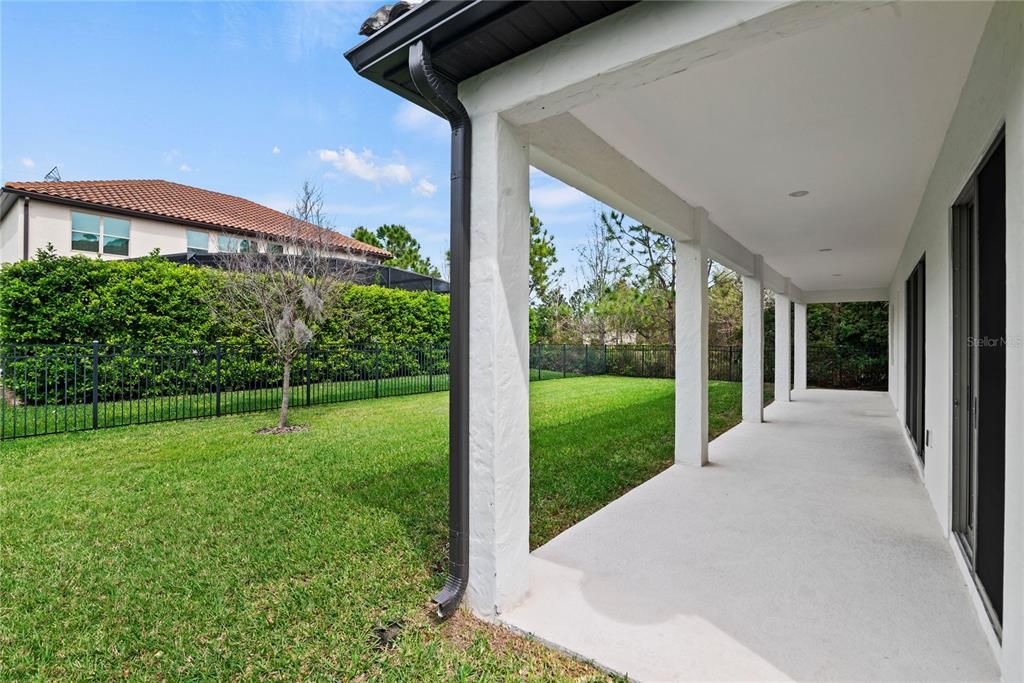 A covered lanai extends the length of home and a fenced in back yard with surrounding mature landscape provides a private space to relax. Ample space to add a pool.