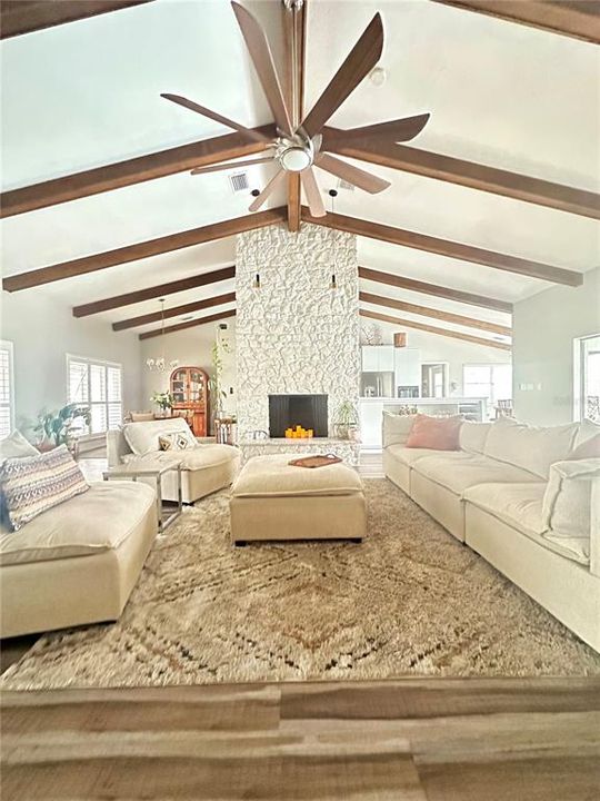 Open floor plan family room with stone fireplace