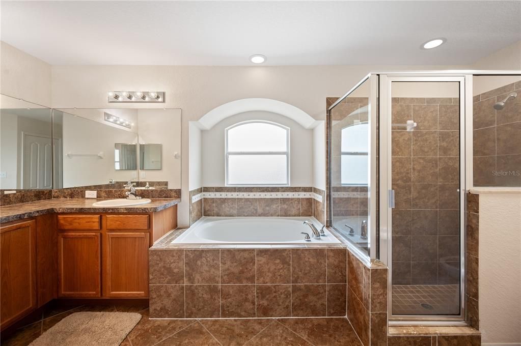Primary bathroom with large garden tub and walk in shower