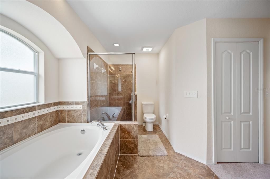 Garden tub and walk in shower in primary bathroom