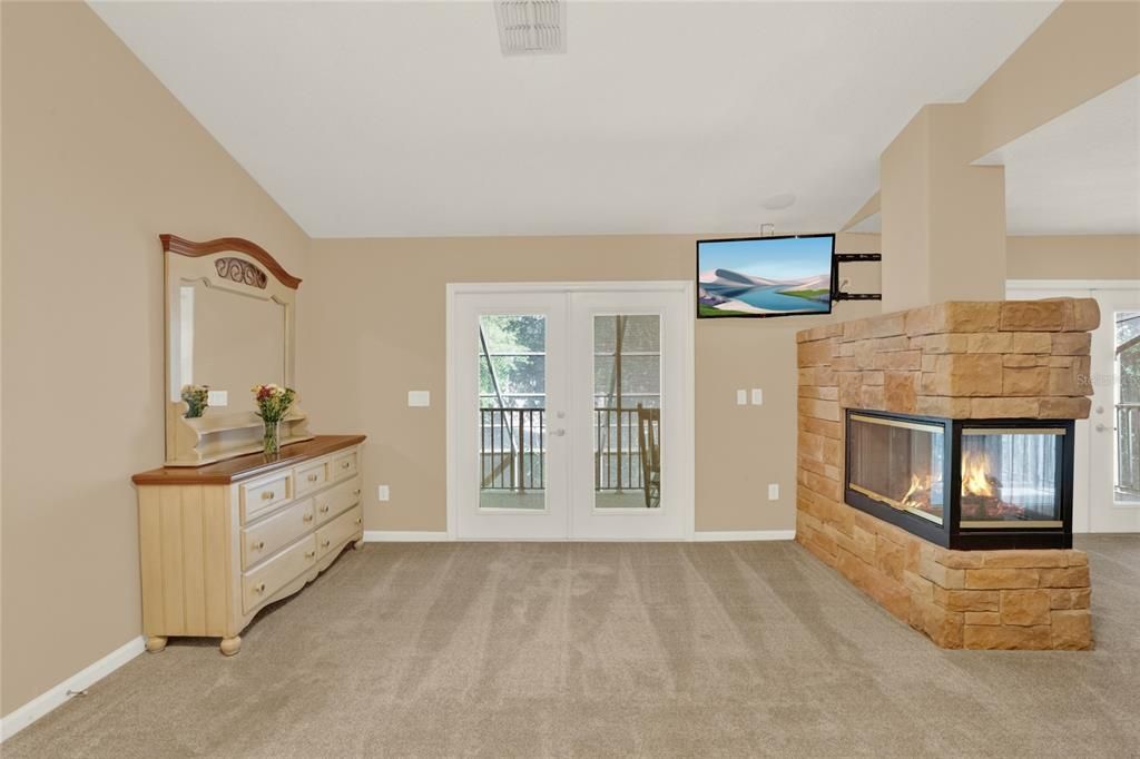 Entryway to balcony and gas fireplace
