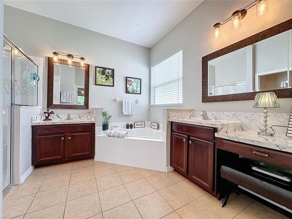 PRIMARY BATH is spa-like complete with DUAL VANITIES, PRIVATE WATER CLOSET