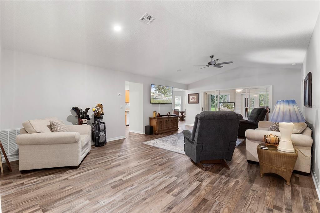 Living room with Luxury Vinyl Plank Flooring, Cathedral Ceilings.