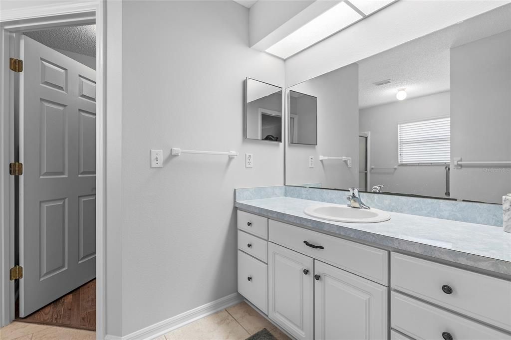 Ensuite bath with TILE flooring, large walk-in closet.