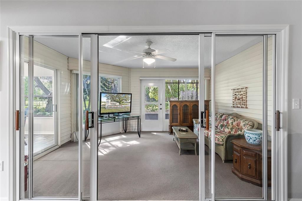 Sliding doors off living room leading out to enclosed lanai.