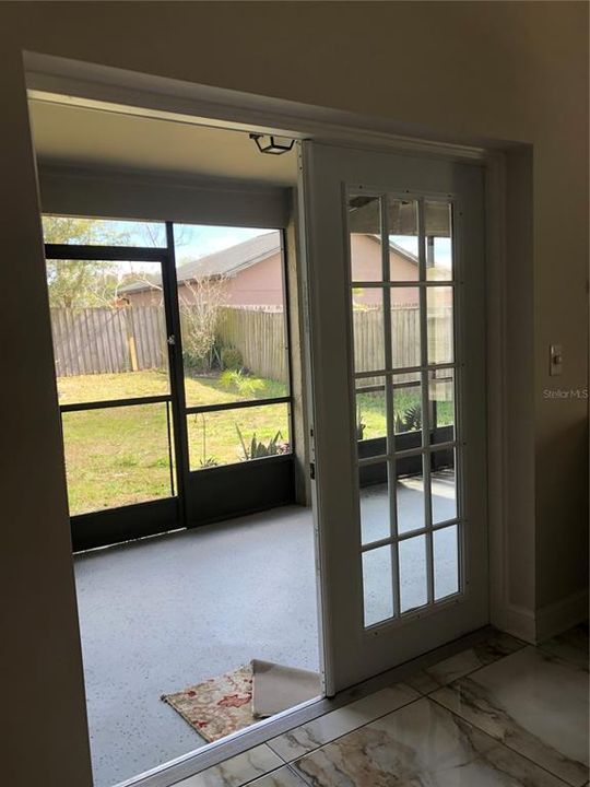 French Doors lead inti screened patio and fenced back yard