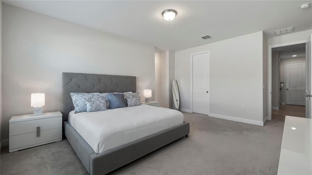 Large Primary Suite features huge walk-in closet and spa-like bath with large corner soaking tub, walk-in shower, quartz countertops, and double vanities.